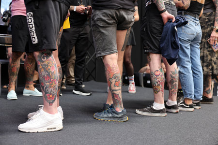 Krakow, Poland - June 11, 2022: Unidentified participant during the contest for the best tattoo at the 15th Tattoofest Convention in Cracow. One of the most prestigious tattoo festivals.のeditorial素材