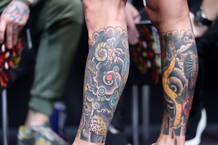 Krakow, Poland - June 11, 2022: Unidentified participant during the contest for the best tattoo at the 15th Tattoofest Convention in Cracow. One of the most prestigious tattoo festivals.のeditorial素材