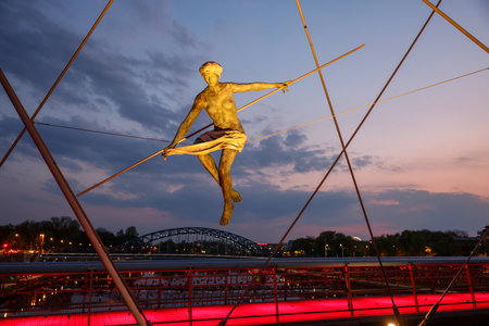 Cracow, Poland - May 2, 2022: Balancing sculptures between sky and water by Jerzy Kedziora over the Kornatka footbridge over the Vistula River in Krakowのeditorial素材