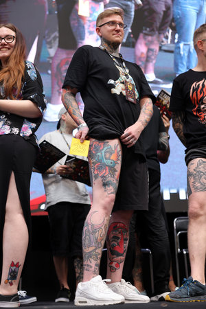Krakow, Poland - June 11, 2022: Unidentified participant during the contest for the best tattoo at the 15th Tattoofest Convention in Cracow. One of the most prestigious tattoo festivals.のeditorial素材