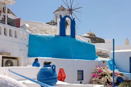 Whitewashed houses and windmill in Oia on Santorini island, Cyclades, Greeceの写真素材
