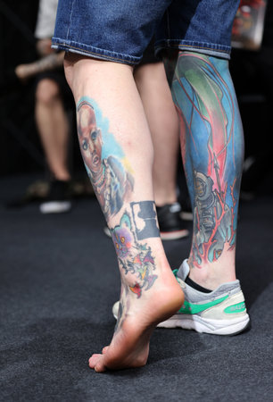Krakow, Poland - June 11, 2022: Unidentified participant during the contest for the best tattoo at the 15th Tattoofest Convention in Cracow. One of the most prestigious tattoo festivals.のeditorial素材