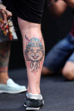 Krakow, Poland - June 11, 2022: Unidentified participant during the contest for the best tattoo at the 15th Tattoofest Convention in Cracow. One of the most prestigious tattoo festivals.のeditorial素材
