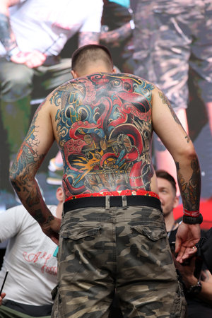 Krakow, Poland - June 11, 2022: Unidentified participant during the contest for the best tattoo at the 15th Tattoofest Convention in Cracow. One of the most prestigious tattoo festivals.のeditorial素材