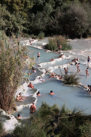 Saturnia, Italy - September 13, 2022: People are bathing in the hot springs of Saturnia Therme,...