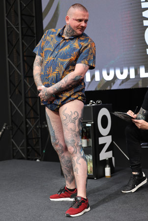 Krakow, Poland - June 12, 2022: Unidentified participant during the contest for the best tattoo at the 15th Tattoofest Convention in Cracow. One of the most prestigious tattoo festivals.のeditorial素材