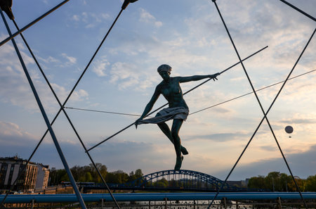 Cracow, Poland - May 2, 2022: Balancing sculptures between sky and water by Jerzy KÄdziora over the Kornatka footbridge over the Vistula River in Krakowのeditorial素材