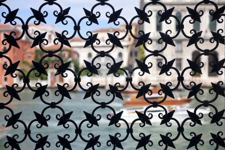 Detail of an ancient window with grating in wrought iron. Venice, Italy,の写真素材