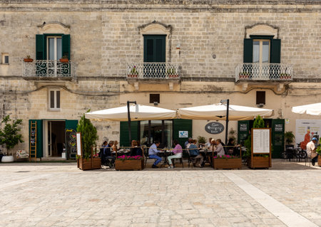 Matera, Italy - September 20, 2019: Tourists are relaxing in one of the many cafes in Sassi di Matera in Matera. Basilicata, Italyのeditorial素材
