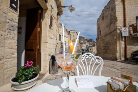 Matera, Italy - September 20, 2019: Aperol Spritz drunk on an empty table in a cafe in Matera. Basilicata. Italyのeditorial素材