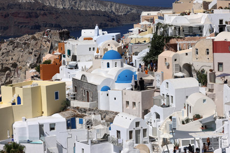 Oia, Santorini, Greece - July 3, 2021: Whitewashed buildings on the edge of the caldera cliff in Oia village, Santorini, Greeceのeditorial素材