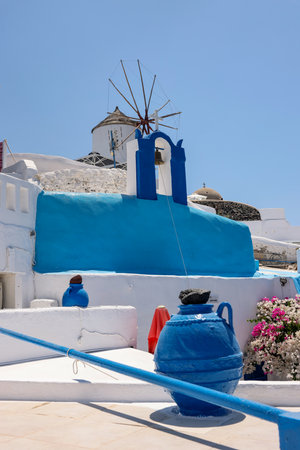 Whitewashed houses and windmill in Oia on Santorini island, Cyclades, Greeceの写真素材