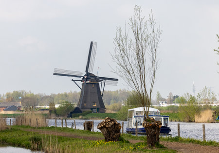 Kinderdijk, the Netherlands - April 17, 2023: 19 windmills at Kinderdijk built about 1740 is part of a larger water management system to prevent flooding. A UNESCO world heritage site.のeditorial素材