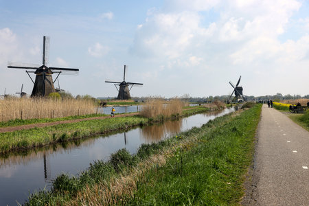 Kinderdijk, the Netherlands - April 17, 2023: 19 windmills at Kinderdijk built about 1740 is part of a larger water management system to prevent flooding. A UNESCO world heritage site.のeditorial素材