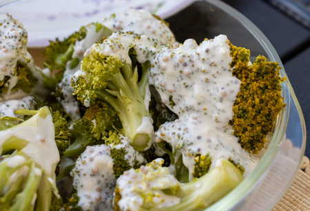 Healthy diet. Steamed broccoli topped with yogurt sauceの写真素材