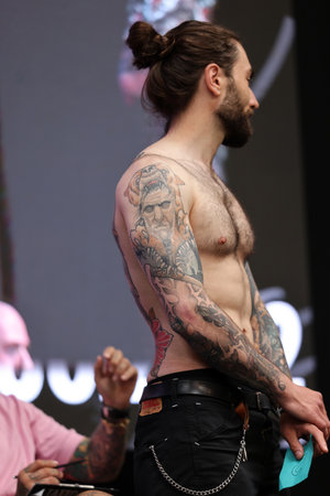 Krakow, Poland - June 11, 2022: Unidentified participant during the contest for the best tattoo at the 15th Tattoofest Convention in Cracow. One of the most prestigious tattoo festivals.のeditorial素材
