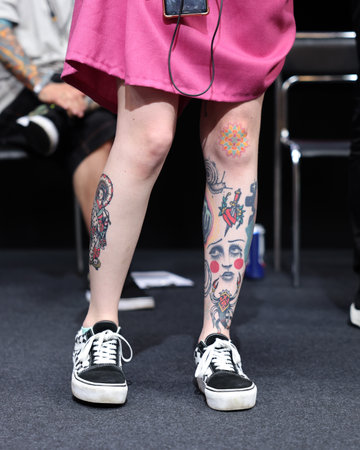 Krakow, Poland - June 11, 2022: Unidentified participant during the contest for the best tattoo at the 15th Tattoofest Convention in Cracow. One of the most prestigious tattoo festivals.のeditorial素材