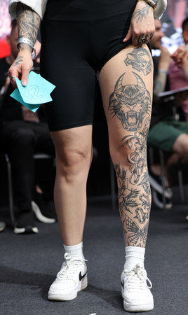 Krakow, Poland - June 11, 2022: Unidentified participant during the contest for the best tattoo at the 15th Tattoofest Convention in Cracow. One of the most prestigious tattoo festivals.のeditorial素材