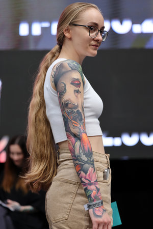 Krakow, Poland - June 12, 2022: Unidentified participant during the contest for the best tattoo at the 15th Tattoofest Convention in Cracow. One of the most prestigious tattoo festivals.のeditorial素材