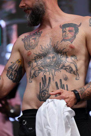 Krakow, Poland - June 11, 2022: Unidentified participant during the contest for the best tattoo at the 15th Tattoofest Convention in Cracow. One of the most prestigious tattoo festivals.のeditorial素材