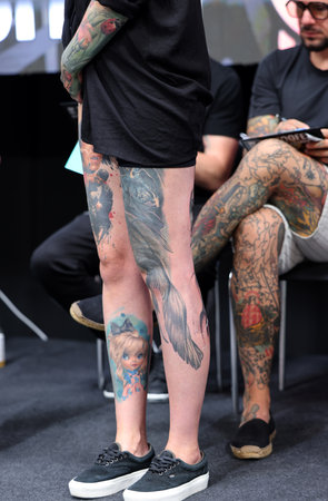 Krakow, Poland - June 12, 2022: Unidentified participant during the contest for the best tattoo at the 15th Tattoofest Convention in Cracow. One of the most prestigious tattoo festivals.のeditorial素材