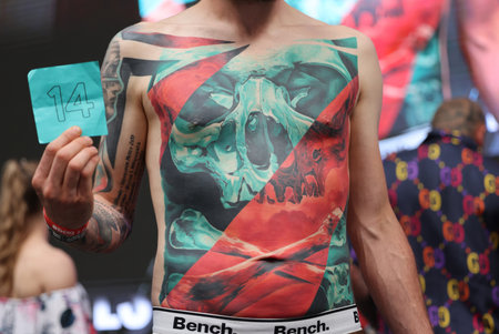 Krakow, Poland - June 12, 2022: Unidentified participant during the contest for the best tattoo at the 15th Tattoofest Convention in Cracow. One of the most prestigious tattoo festivals.のeditorial素材