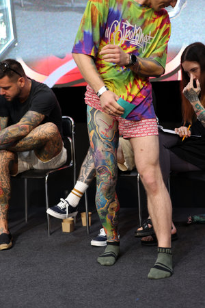 Krakow, Poland - June 12, 2022: Unidentified participant during the contest for the best tattoo at the 15th Tattoofest Convention in Cracow. One of the most prestigious tattoo festivals.のeditorial素材