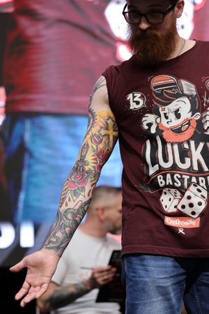 Krakow, Poland - June 11, 2022: Unidentified participant during the contest for the best tattoo at the 15th Tattoofest Convention in Cracow. One of the most prestigious tattoo festivals.のeditorial素材