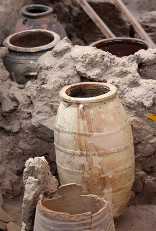 Santorini, Greece - July 01, 2021: Recovered ancient pottery in prehistoric town of Akrotiri, excavation site of a Minoan Bronze Age settlement on the Greek island of Santoriniのeditorial素材