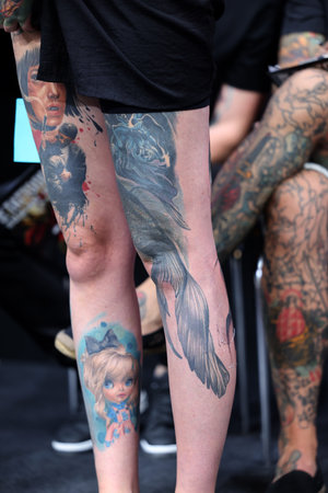 Krakow, Poland - June 12, 2022: Unidentified participant during the contest for the best tattoo at the 15th Tattoofest Convention in Cracow. One of the most prestigious tattoo festivals.のeditorial素材