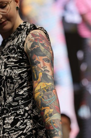 Krakow, Poland - June 11, 2022: Unidentified participant during the contest for the best tattoo at the 15th Tattoofest Convention in Cracow. One of the most prestigious tattoo festivals.のeditorial素材