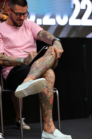 Krakow, Poland - June 11, 2022: Unidentified participant during the contest for the best tattoo at the 15th Tattoofest Convention in Cracow. One of the most prestigious tattoo festivals.のeditorial素材