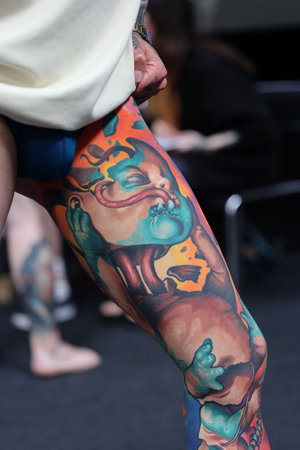 Krakow, Poland - June 12, 2022: Unidentified participant during the contest for the best tattoo at the 15th Tattoofest Convention in Cracow. One of the most prestigious tattoo festivals.のeditorial素材