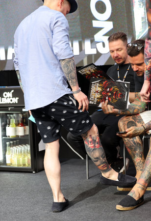 Krakow, Poland - June 12, 2022: Unidentified participant during the contest for the best tattoo at the 15th Tattoofest Convention in Cracow. One of the most prestigious tattoo festivals.のeditorial素材
