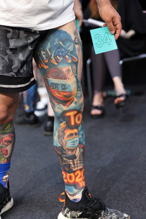 Krakow, Poland - June 12, 2022: Unidentified participant during the contest for the best tattoo at the 15th Tattoofest Convention in Cracow. One of the most prestigious tattoo festivals.のeditorial素材