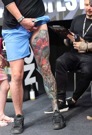 Krakow, Poland - June 12, 2022: Unidentified participant during the contest for the best tattoo at the 15th Tattoofest Convention in Cracow. One of the most prestigious tattoo festivals.のeditorial素材