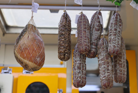 Cremona, Italy - September 7, 2022: Traditional meat products sold at a street stall during the farmers market in Cremona, Lombardy, Italyのeditorial素材
