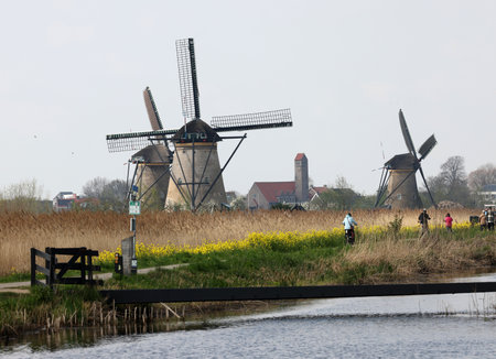 Kinderdijk, the Netherlands - April 17, 2023: 19 windmills at Kinderdijk built about 1740 is part of a larger water management system to prevent flooding. A UNESCO world heritage site.のeditorial素材
