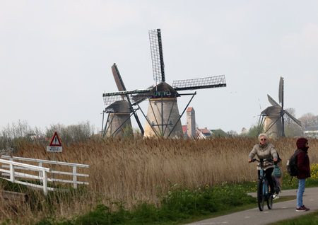 Kinderdijk, the Netherlands - April 17, 2023: 19 windmills at Kinderdijk built about 1740 is part of a larger water management system to prevent flooding. A UNESCO world heritage site.のeditorial素材