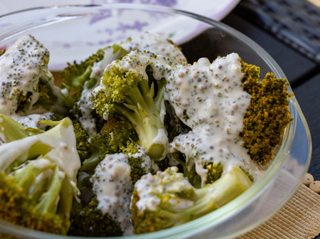 Healthy diet. Steamed broccoli topped with yogurt sauceの写真素材