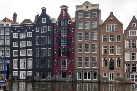 Amsterdam, Netherlands - April 21, 2023: Typical gabled houses on Damrak street in Amsterdam, Holland, Netherlandsのeditorial素材