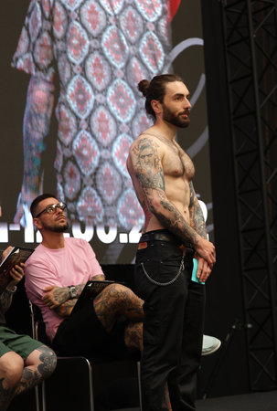 Krakow, Poland - June 11, 2022: Unidentified participant during the contest for the best tattoo at the 15th Tattoofest Convention in Cracow. One of the most prestigious tattoo festivals.のeditorial素材