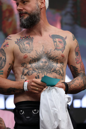 Krakow, Poland - June 11, 2022: Unidentified participant during the contest for the best tattoo at the 15th Tattoofest Convention in Cracow. One of the most prestigious tattoo festivals.のeditorial素材