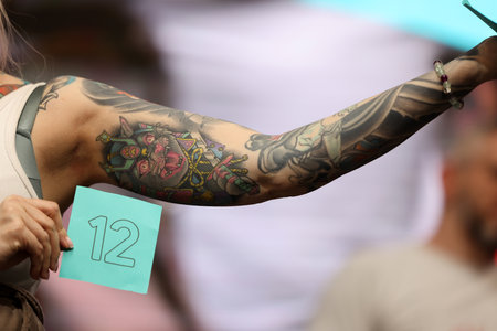 Krakow, Poland - June 11, 2022: Unidentified participant during the contest for the best tattoo at the 15th Tattoofest Convention in Cracow. One of the most prestigious tattoo festivals.のeditorial素材