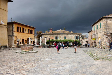 Monteriggioni, Italy - Sept 17, 2022: Piazza Roma in Monteriggioni medieval walled town, moments before an approaching large storm. Tuscany, Italyのeditorial素材