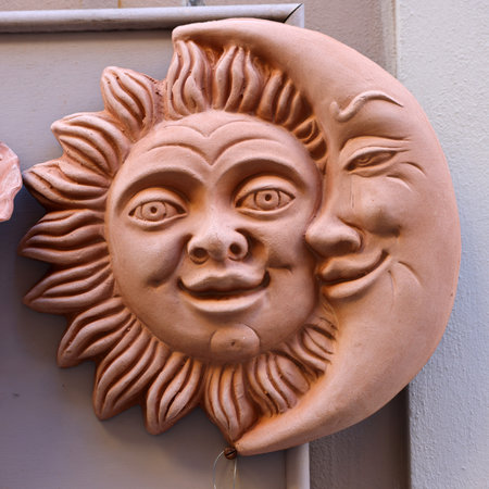 Massa Italy - Sept 11, 2022: Lovely sun and moon couple on the window of a shop with typical Italian ceramics in Massa Maritima. Tuscany, Italyのeditorial素材