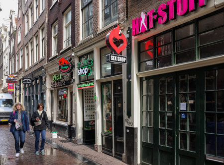 Amsterdam, Netherlands - April 21, 2023: De Wallen - called the red light district. It is famous for its entertainment character: brothers, coffee shops, pubs and restaurants located along the canalsのeditorial素材