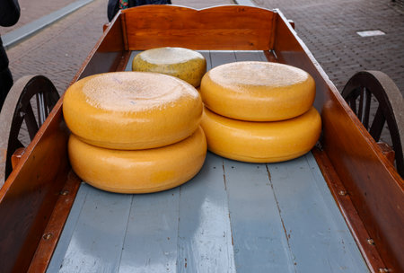 Whole round cheeses for sale at the cheese market in Gouda, the Netherlandsの写真素材
