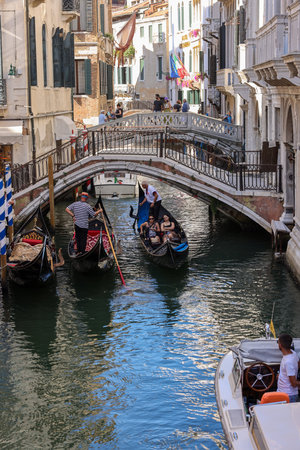 Venice, Italy - September 5, 2022: One of the most recognizable tourist attractions in the world - a gondola cruise through the narrow canals in Veniceのeditorial素材
