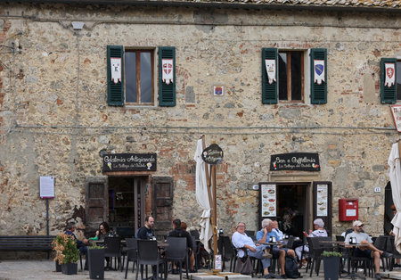 Monteriggioni, Italy - Sept 17, 2022: Restaurant in Piazza Roma in Monteriggioni medieval walled town near Siena in Tuscany, Italyのeditorial素材
